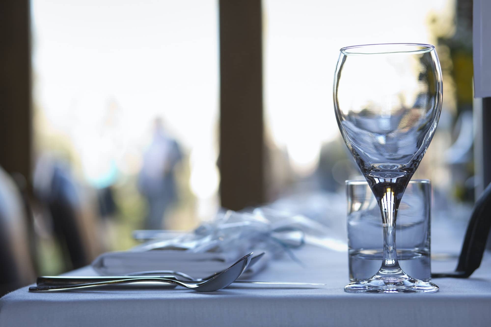 Close up of crockery and cutlery on a table.